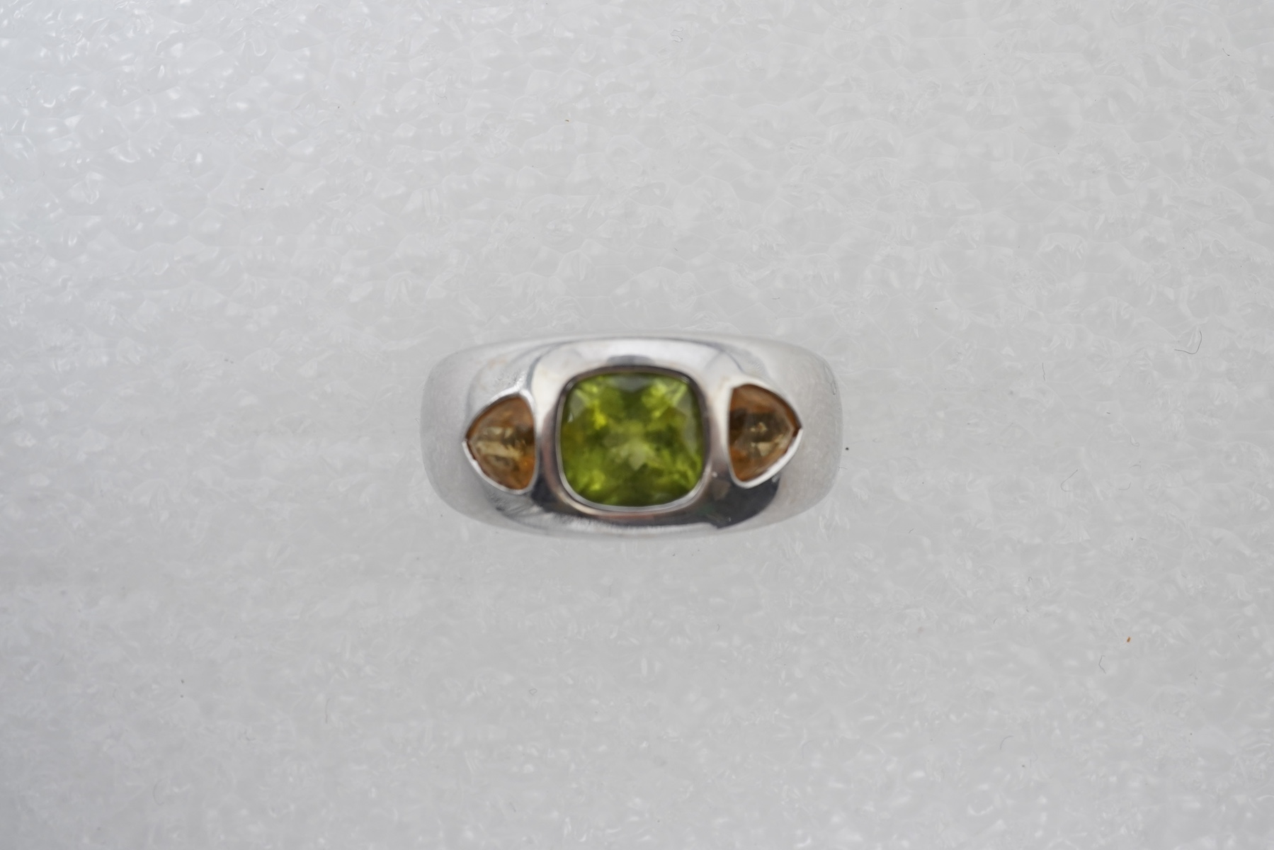 A peridot and citrine dress ring